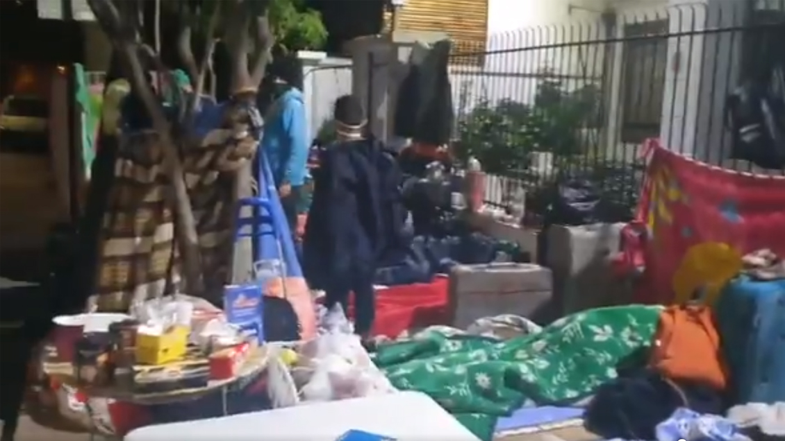 Migrantes venezolanos sin techo cumplen una semana pernoctando ante embajada en Chile